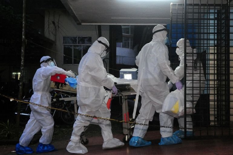 Medics attend to a patient in an isolation ward.